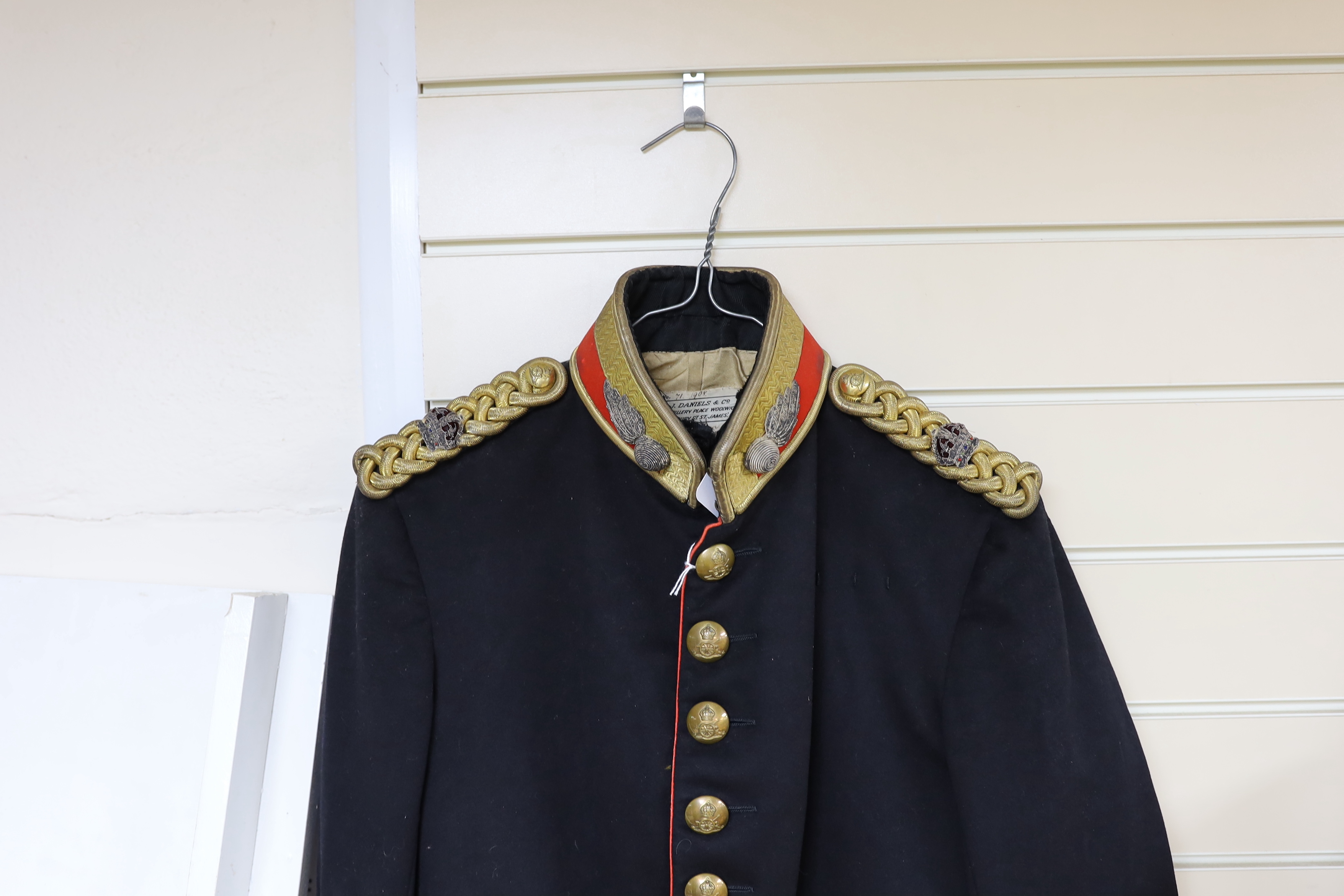 An early 20th century Royal Artillery officers dress uniform, comprising a jacket and trousers, both with original maker’s labels for J. Daniels and Co., with owner’s name ‘Major G.H. Tristram R.A.’ added in pen, a Mess